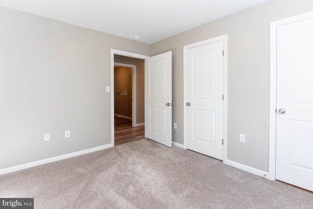 unfurnished bedroom with carpet and baseboards