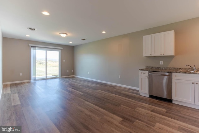 kitchen with stainless steel dishwasher, a sink, dark wood-style flooring, white cabinetry, and recessed lighting