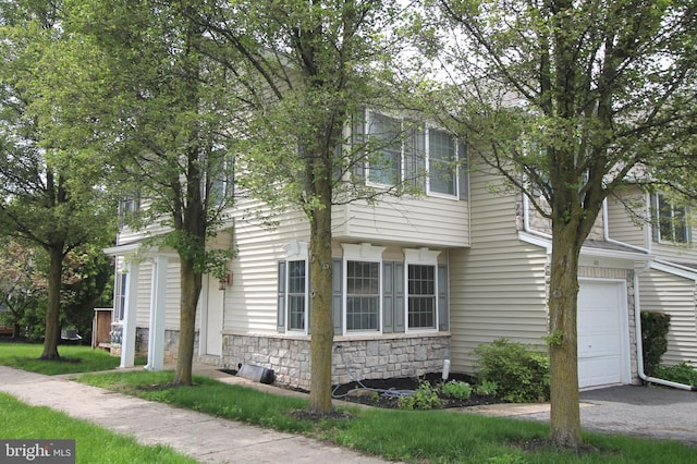100 Lincoln Ave, State College, PA 16801 - view of home's exterior featuring stone siding, an attached garage, and asphalt driveway
