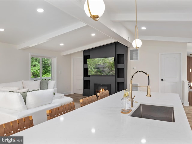 139 Laura Ct, Basye, VA 22810 - kitchen featuring a sink, beam ceiling, wood finished floors, recessed lighting, and a fireplace