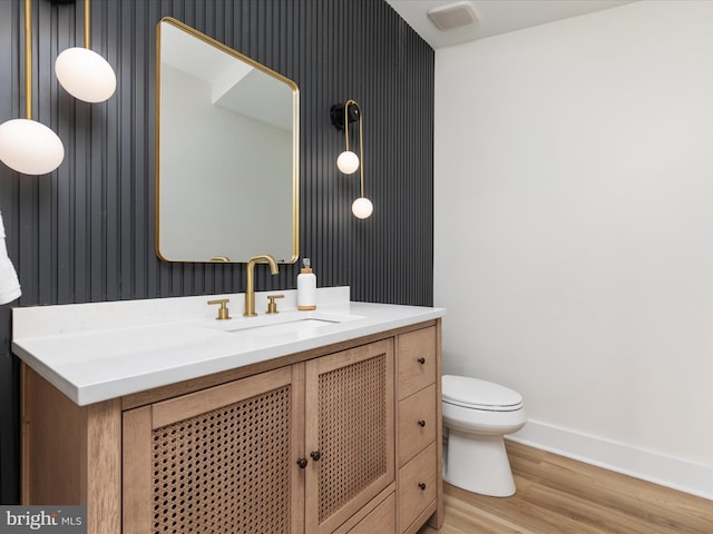 139 Laura Ct, Basye, VA 22810 - bathroom with wallpapered walls, vanity, wood finished floors, toilet, and baseboards