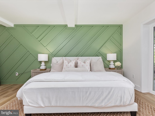 139 Laura Ct, Basye, VA 22810 - bedroom featuring a decorative wall, wood finished floors, beamed ceiling, and baseboards