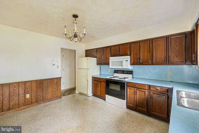 320 Dawn Ave, Woodstock, VA 22664 - kitchen with white appliances, a chandelier, light countertops, light flooring, and pendant lighting