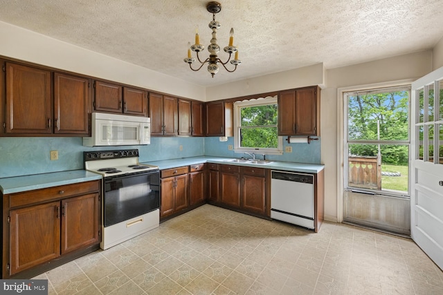 320 Dawn Ave, Woodstock, VA 22664 - kitchen featuring white appliances, a sink, a chandelier, light countertops, and light floors