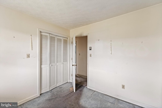 320 Dawn Ave, Woodstock, VA 22664 - unfurnished bedroom featuring carpet, a closet, a textured ceiling, and baseboards
