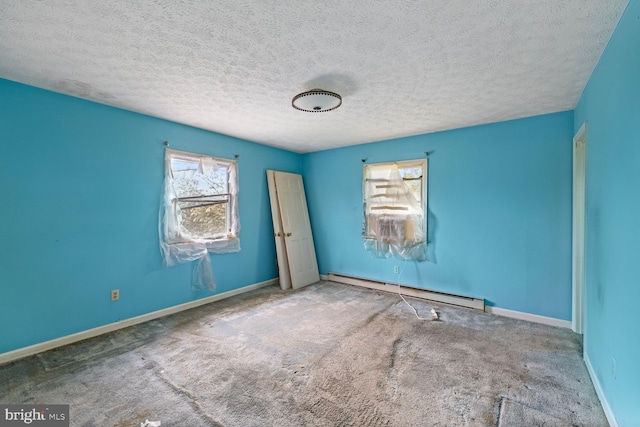 320 Dawn Ave, Woodstock, VA 22664 - carpeted empty room featuring a baseboard heating unit, plenty of natural light, a textured ceiling, and baseboards