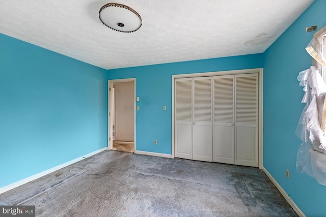 320 Dawn Ave, Woodstock, VA 22664 - unfurnished bedroom with carpet floors, a closet, baseboards, and a textured ceiling