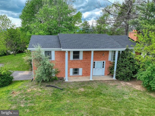 320 Dawn Ave, Woodstock, VA 22664 - back of property with a shingled roof, a patio, brick siding, a yard, and a chimney