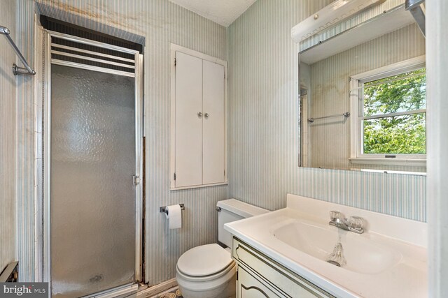 320 Dawn Ave, Woodstock, VA 22664 - full bath with wallpapered walls, a shower stall, toilet, and vanity