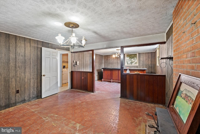 320 Dawn Ave, Woodstock, VA 22664 - kitchen featuring wooden walls, tile patterned floors, a chandelier, a textured ceiling, and washer / clothes dryer