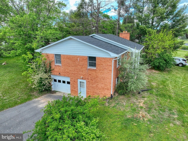 320 Dawn Ave, Woodstock, VA 22664 - view of side of home with driveway, a chimney, brick siding, and a garage