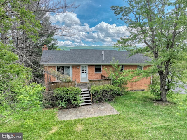 320 Dawn Ave, Woodstock, VA 22664 - view of front of home with brick siding, a front yard, a chimney, stairway, and a wooden deck
