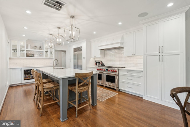 11013 Homeplace Ln, Potomac, MD 20854 - kitchen with high end appliances, custom range hood, backsplash, white cabinetry, and open shelves