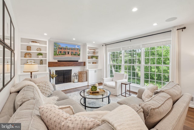 11013 Homeplace Ln, Potomac, MD 20854 - living room featuring wood finished floors, a fireplace, recessed lighting, and built in features