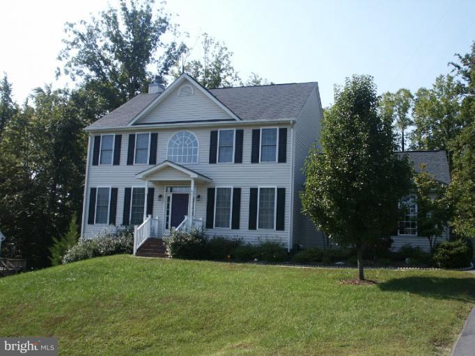 11612 Hoover Ln, Fredericksburg, VA 22407 - colonial-style house with a front yard and a chimney