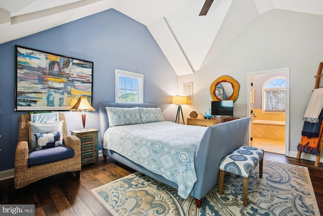 bedroom featuring wood finished floors, ensuite bath, and high vaulted ceiling