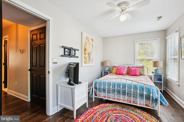 bedroom with wood finished floors, baseboards, and ceiling fan
