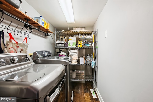 laundry room featuring washing machine and clothes dryer and dark wood-type flooring