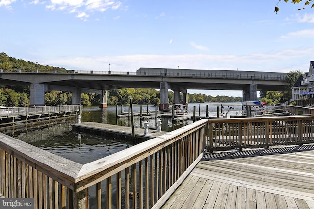 dock area with a water view and boat lift
