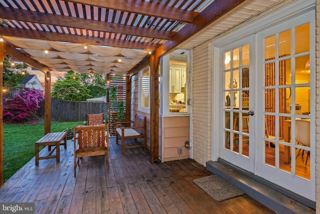 deck featuring fence, a pergola, and french doors