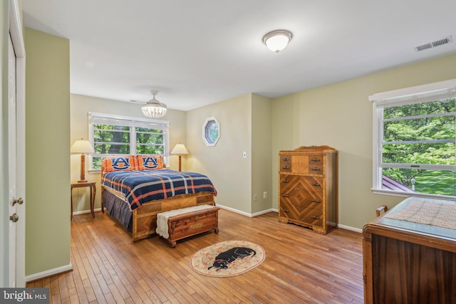 6813 Jeremiah Ct, Fairfax Station, VA 22039 - bedroom featuring light wood-style flooring, baseboards, and a chandelier