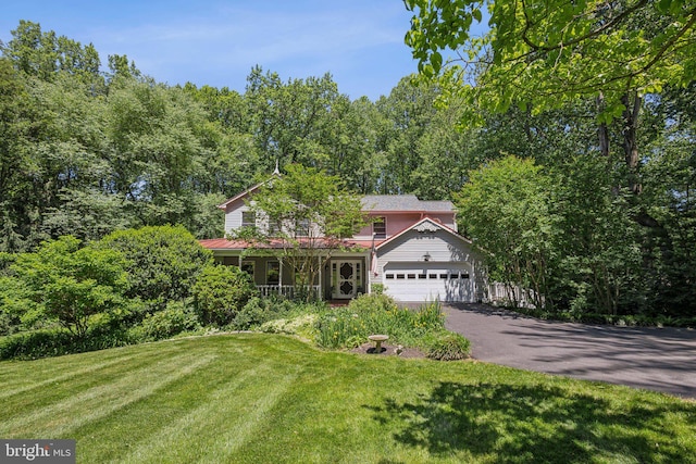 6813 Jeremiah Ct, Fairfax Station, VA 22039 - view of front of home featuring a front lawn, asphalt driveway, a porch, an attached garage, and a view of trees