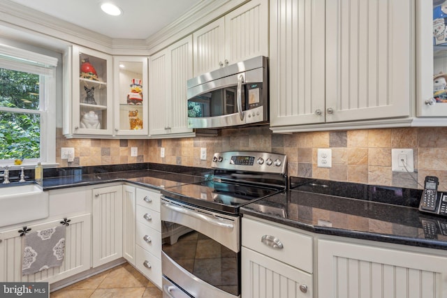6813 Jeremiah Ct, Fairfax Station, VA 22039 - kitchen with appliances with stainless steel finishes, dark stone countertops, a sink, backsplash, and glass insert cabinets