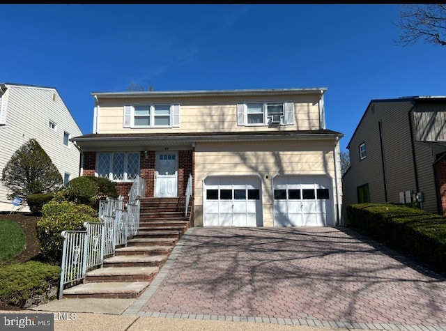 47 George St, Bloomfield, NJ 07003 - traditional home with decorative driveway, an attached garage, and brick siding