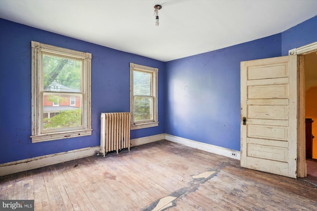 3101 Perry St, Mount Rainier, MD 20712 - unfurnished room featuring radiator heating unit, healthy amount of natural light, and wood-type flooring
