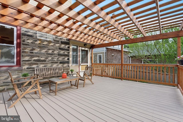 wooden terrace featuring a pergola and an outdoor living space