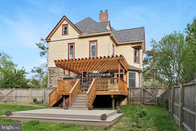 rear view of house with a pergola, a wooden deck, a chimney, stairs, and a shingled roof