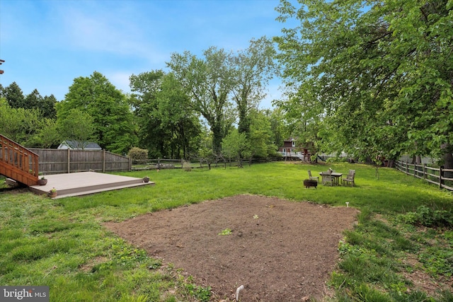 view of yard featuring a fire pit and a patio