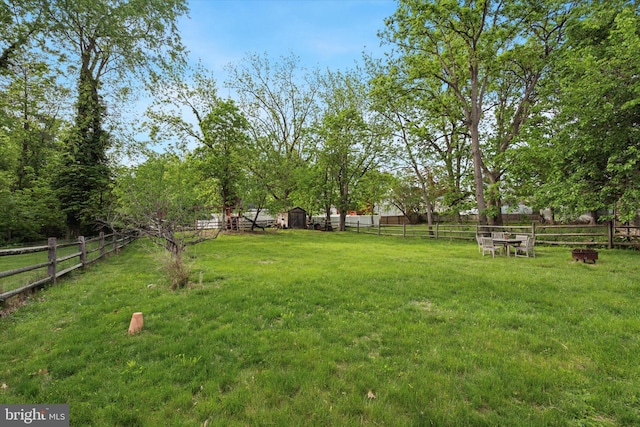 view of yard featuring a storage shed and an outbuilding