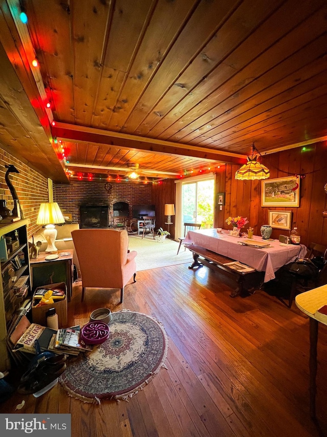 recreation room with wooden ceiling, wood-type flooring, brick wall, and wood walls
