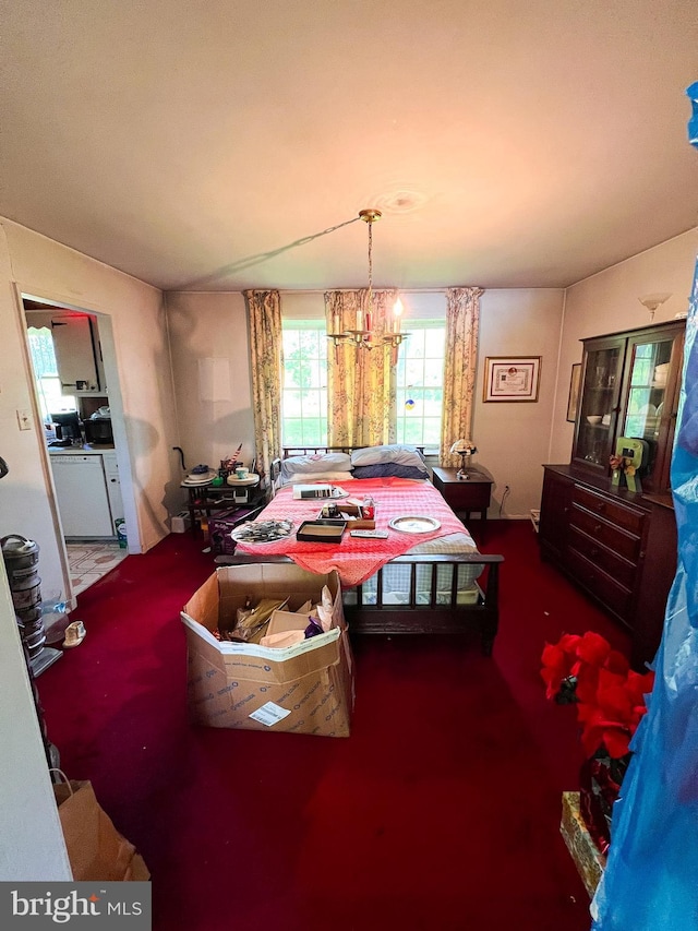 carpeted bedroom with a chandelier