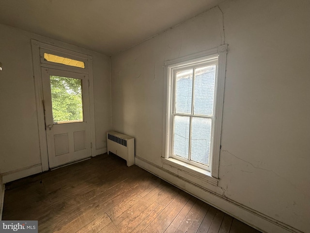 entryway with radiator heating unit and wood-type flooring