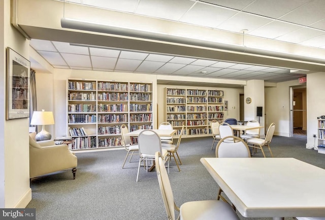 4201 Cathedral Ave NW Unit 415E, Washington, DC 20016 - office with bookshelves, carpet flooring, a paneled ceiling, baseboards, and built in features