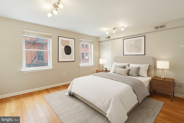 326 S 17th St Unit 3, Philadelphia, PA 19103 - bedroom with track lighting, baseboards, and light wood finished floors