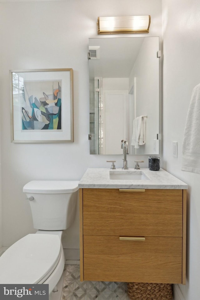 bathroom with toilet and vanity
