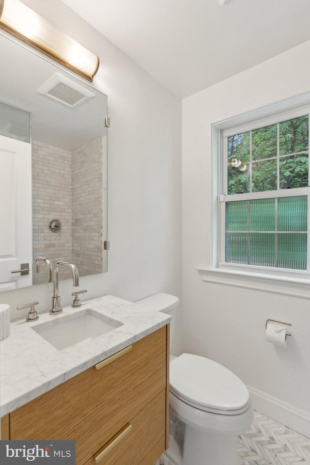 bathroom featuring toilet and vanity