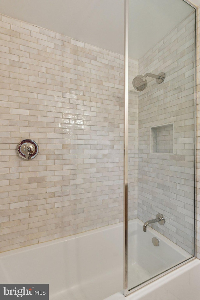 full bathroom featuring bath / shower combo with glass door