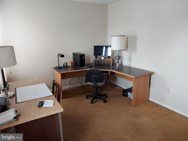 carpeted home office with baseboards