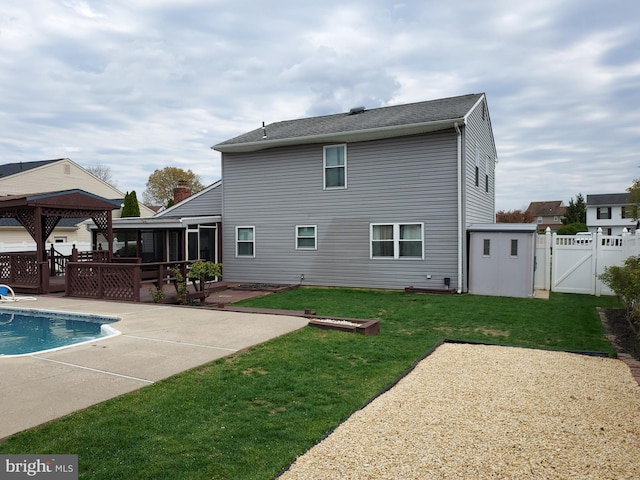 back of property with a gate, a sunroom, a patio, and a wooden deck