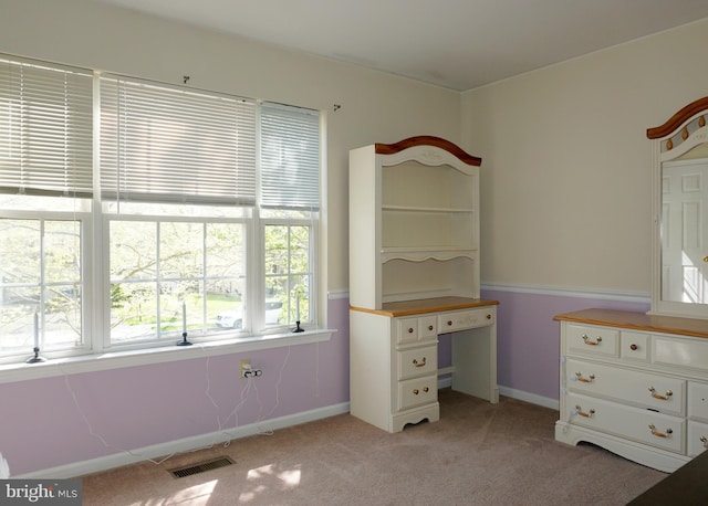 unfurnished bedroom with light carpet and baseboards