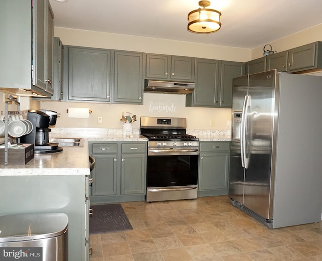kitchen with stainless steel appliances, under cabinet range hood, and light stone counters