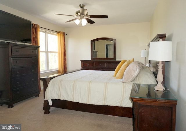 bedroom featuring light colored carpet and ceiling fan