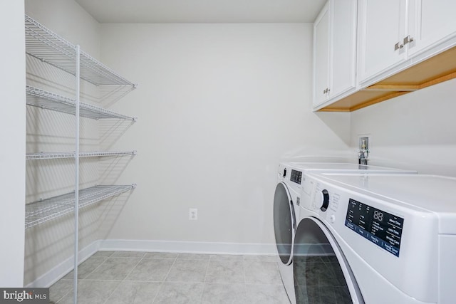 4801 Railway Cir, Monrovia, MD 21770 - laundry area featuring washer and clothes dryer, cabinet space, baseboards, and light tile patterned floors