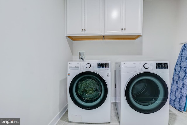 4801 Railway Cir, Monrovia, MD 21770 - laundry area with cabinet space, washing machine and dryer, baseboards, and light tile patterned floors