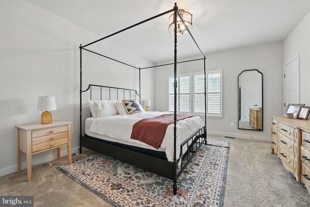 bedroom featuring light carpet and baseboards
