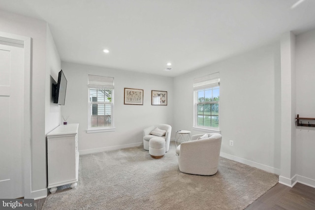 sitting room featuring healthy amount of natural light, baseboards, and recessed lighting